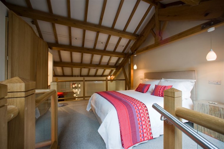 The large king bedroom with its vaulted green oak roof is amazing